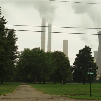 A power plant behind some trees.