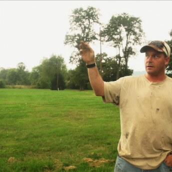 A person talking in front of the camera and using their arms to explain while they speak.