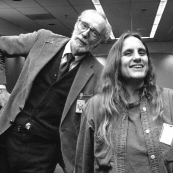 A still in black and white from The Forest for the Trees. Two people stand facing the camera smiling.
