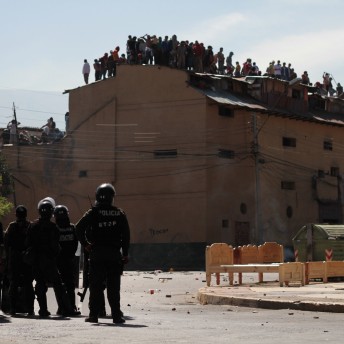 A group of police officers with anti-mutiny equipment in the street.