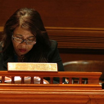 A woman reading in a jury room.