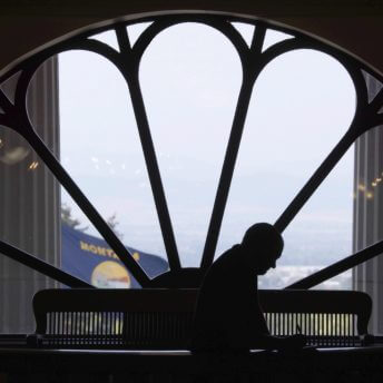 Overshadowed shot of a man in front of a window inside the Capitol.