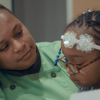 Still from Apart. Tomika is telling her daughter she’s in prison.