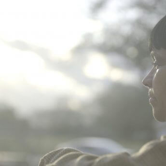 Over shoulder shot of a woman looking away from the camera.