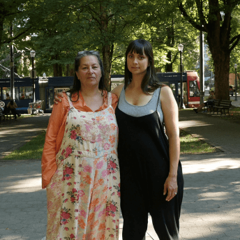 Filmmaker Brooke Pepion Swaney and a woman looking directly at the camera. Brooke hugs the woman.