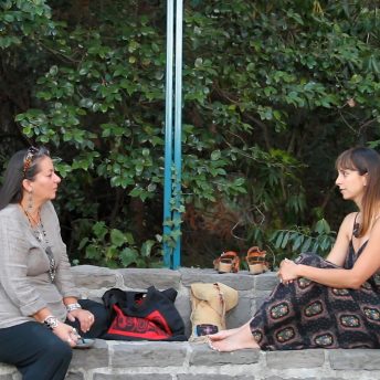 A young and an older woman talking in front of each other.