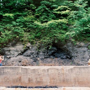 Brett Story takes photographs while sound recordist Ian Reynolds records ambient sound in the Appalachian mountains during the filming of The Prison in Twelve Landscapes.