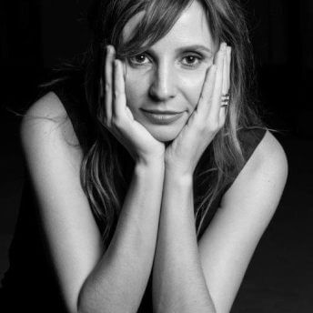 Director Petra Costa’s headshot in black and white