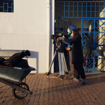 A production crew working with face masks, the camera is in a tripod