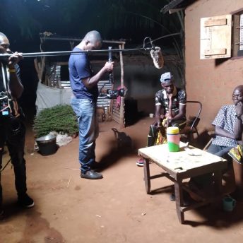 Eat Bitter cinematographer Orphe, sound engineer Aaron, hold their equipment to film Thomas, the character, who has a girl in his arms with one hand trying to reach Thomas' chin. The camera points to the bench, where sit Thomas' father in law and and his wife. The wife buries her head in her hands.