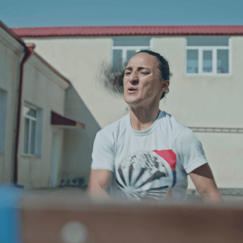 Sose, a world-champion Judoist, trains outside using resistance bands.