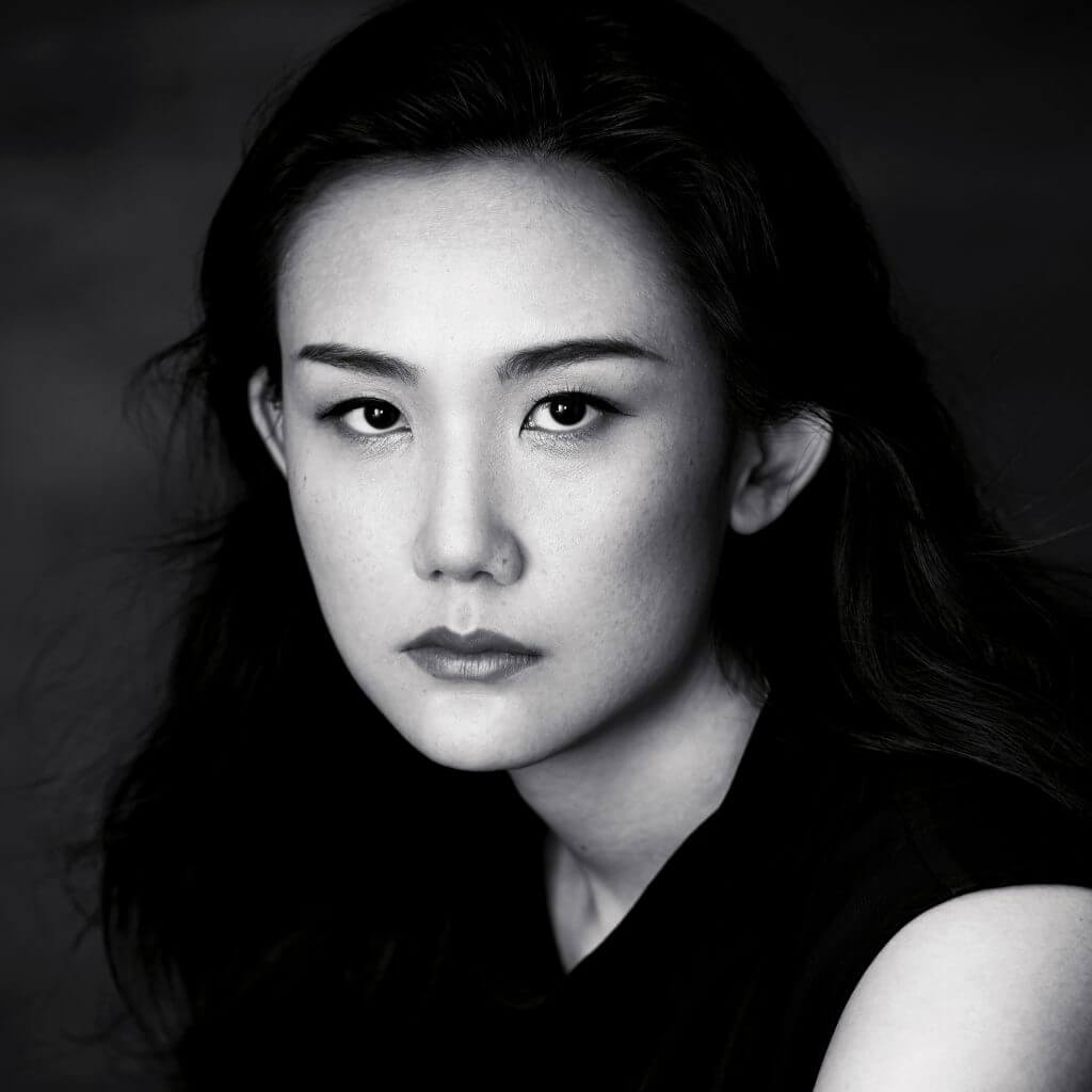 Portrait of a woman with medium dark hair looking at the camera