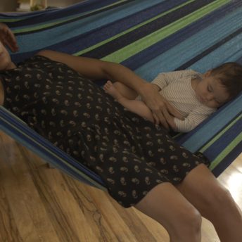 A woman and a baby in a hamock