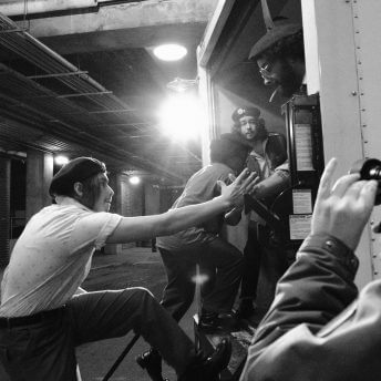 Actors getting inside of the back of a trailer