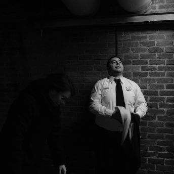 Medium shot of an actor dressed as a police officer looking up to the sky