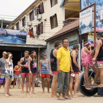 A man is standing in front of a group of tourists.