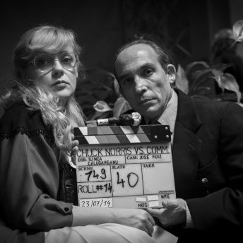 Still from Chuck Norris vs Communism. Ana Maria Moldovan and Dan Chiorean, the actors playing the film’s main characters, pose with the clapboard (photographer Balla Zoltán)