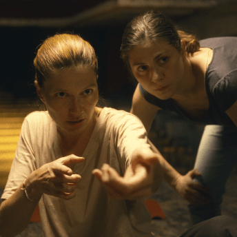 Close up of a woman explaining something to another woman.