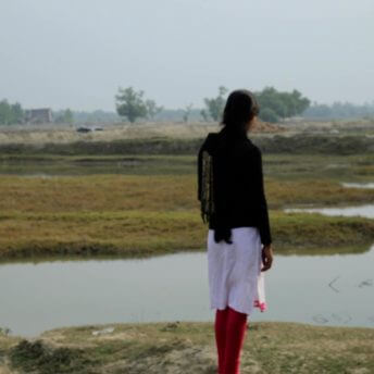 A woman looks off into the distance