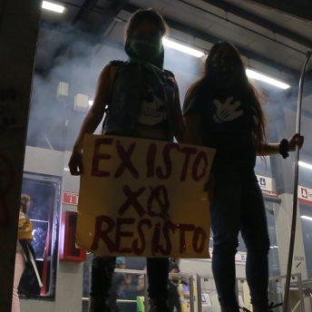 Hundreds of women protest after three women, two of them minors, were raped by police officers, by painting walls and breaking glass at the Glorieta de los Insurgentes, a landmark in Mexico City located in front of the Secretariat of social Security. In the picture we can see two young women with a banner that says "I exist because I resist".