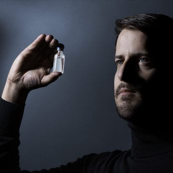 Scott Alexander Ruderman (director) holding a vial of Alec Smith's ashes